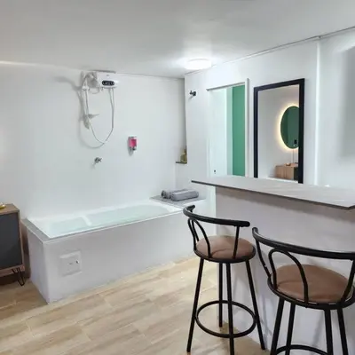 two chairs sitting at a counter in a bathroom at Loft with bathtub in Laureles in Medellín