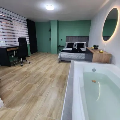 a bedroom with a bed and a bath tub in a room at Loft with bathtub in Laureles in Medellín