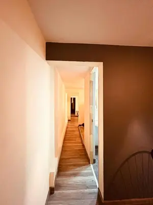a hallway of a house with wooden floors at Renacer, Poblado Manila in Medellín