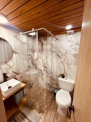 a bathroom with a toilet and a sink at Renacer, Poblado Manila in Medellín