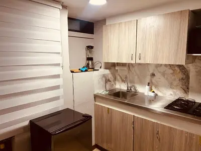 a small kitchen with a sink and a counter at Renacer, Poblado Manila in Medellín