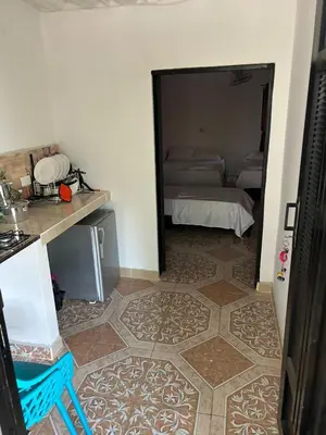 a room with a room with a bed and a mirror at Alojamiento Doradal Antioquía, en el santorini colombiano, la aldea in Doradal