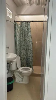 a bathroom with a toilet and a sink and a shower at Alojamiento Doradal Antioquía, en el santorini colombiano, la aldea in Doradal