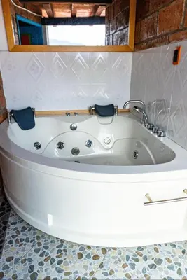 a white bath tub in a bathroom with a window at Suite Master in Jericó