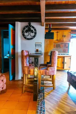a kitchen with a table and chairs in a room at Suite Master in Jericó
