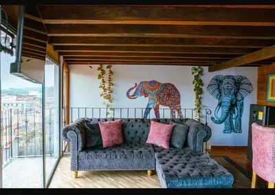 a living room with a couch and an elephant on the wall at Suite Master in Jericó