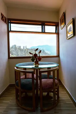 a room with a table and two chairs and a window at Suite Encanto in Jericó