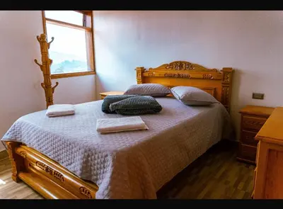 a bedroom with a bed with two towels on it at Suite Encanto in Jericó