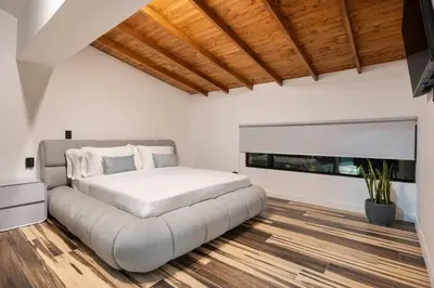 a white bedroom with a large bed in a room at Private Sauna Jacuzzi Billiard Gym Luxury Retreat in El Poblado