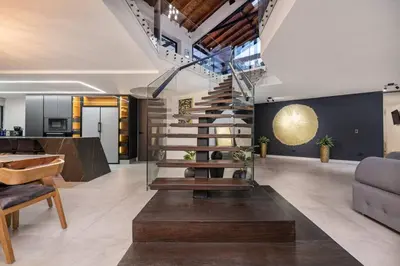 a living room with a staircase and a couch at Private Sauna Jacuzzi Billiard Gym Luxury Retreat in El Poblado