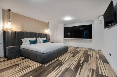 a bedroom with a large bed and a flat screen tv at Private Sauna Jacuzzi Billiard Gym Luxury Retreat in El Poblado