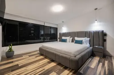 a bedroom with a large bed and a large window at Private Sauna Jacuzzi Billiard Gym Luxury Retreat in El Poblado