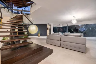 a living room with a couch and a staircase at Private Sauna Jacuzzi Billiard Gym Luxury Retreat in El Poblado