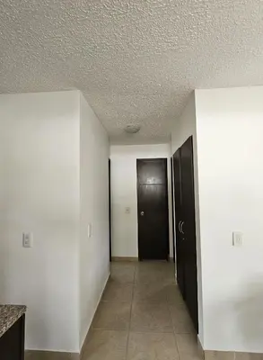 an empty hallway with a black door and a room at Apartasol Ciudadela Santa Fé 