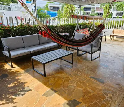 a hammock and two chairs and a couch and a table at Apartasol Ciudadela Santa Fé 