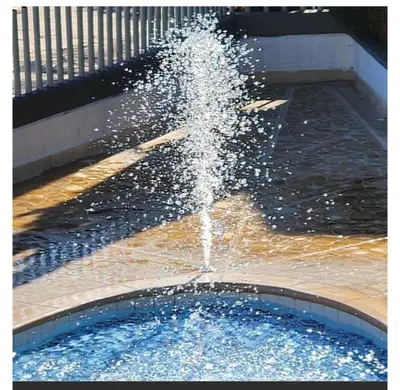 a water fountain in a pool of water at Apartasol Ciudadela Santa Fé 
