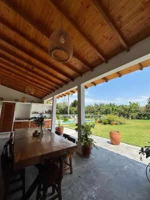 a dining room with a wooden table and a ceiling at TERRAKOTA Heritage House in Mariquita