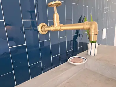 a bathroom sink with a gold faucet and a bowl at TERRAKOTA Heritage House in Mariquita