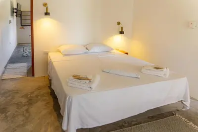 a bedroom with a white bed with towels on it at TERRAKOTA Heritage House in Mariquita