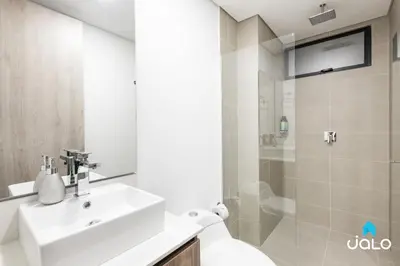 a bathroom with a sink and a toilet and a shower at Kyux Studios by Jalo - Laureles in Medellín