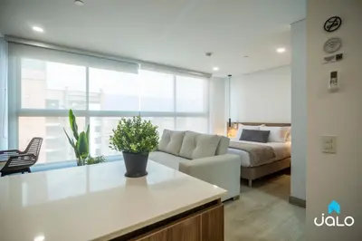 a living room with a couch and a bed at Kyux Studios by Jalo - Laureles in Medellín