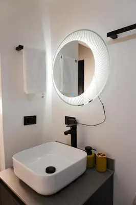 a bathroom with a white sink and a mirror at Clandestino - Hotel Boutique in La Dorada