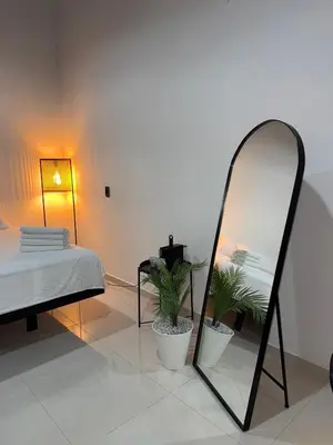 a room with a bed and a mirror and a bed sidx sidx sidx at Clandestino - Hotel Boutique in La Dorada