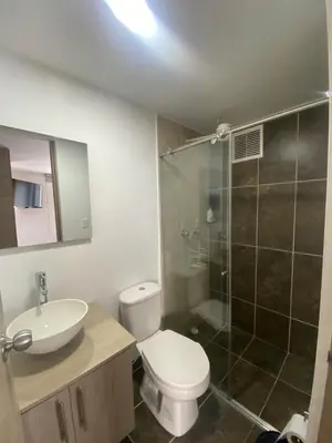 a bathroom with a toilet and a sink and a shower at Apartamento , frente a la universidad autónoma , edificio urban in Manizales