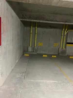 an empty parking lot with yellow piping in a parking garage at Apartamento , frente a la universidad autónoma , edificio urban in Manizales