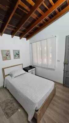 a bedroom with a bed and a window in it at Casa campestre,Guarne-Aeropuerto in Guarne
