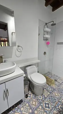 a bathroom with a toilet and a sink at Casa campestre,Guarne-Aeropuerto in Guarne