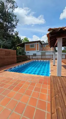 a swimming pool in front of a house at Casa campestre,Guarne-Aeropuerto in Guarne