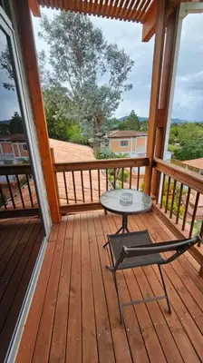 a table and a chair on a wooden deck at Casa campestre,Guarne-Aeropuerto in Guarne