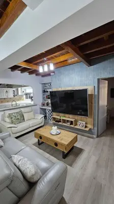 a living room with a couch and a tv at Casa campestre,Guarne-Aeropuerto in Guarne