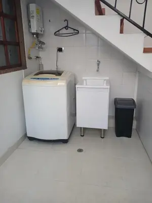 a bathroom with a sink and a washing machine at Comodidad y confort in Olaya Herrera Airport