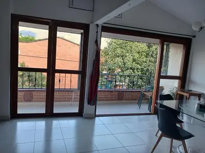 an open door to a balcony with a table and chairs at Comodidad y confort in Olaya Herrera Airport