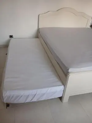 a bed in a room with white sheets at Comodidad y confort in Olaya Herrera Airport