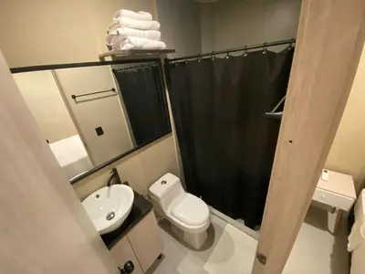 a bathroom with a toilet and a sink and a shower at Hermoso apartamento en el poblado in Medellín