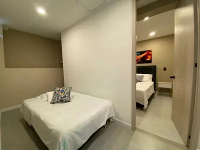 a small room with two beds and a mirror at Hermoso apartamento en el poblado in Medellín