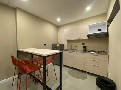 a kitchen with a table and chairs in a room at Hermoso apartamento en el poblado in Medellín