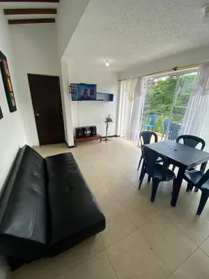 a living room with a couch and a table and chairs at Santa Fe Relax in Santa Fe de Antioquia