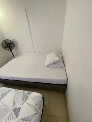 a small room with two beds and a lamp at Santa Fe Relax in Santa Fe de Antioquia