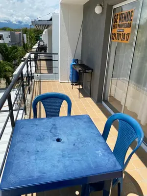 a blue table and two chairs on a balcony at Santa Fe Relax in Santa Fe de Antioquia