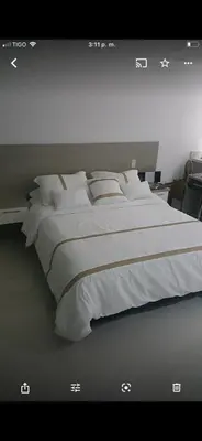 a bedroom with a large bed with white sheets and pillows at Aparta loft in Envigado