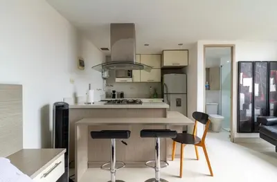 a kitchen with two bar stools and a counter top at Aparta loft in Envigado