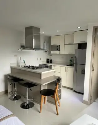 a kitchen with a stove and a chair in it at Aparta loft in Envigado