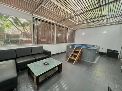 a living room with a couch and a tub at Private Jacuzzi 3 Bedroom apartment in Provenza cartagena in Medellín