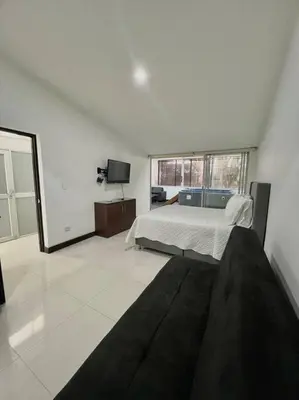 a bedroom with a bed and a television in it at Private Jacuzzi 3 Bedroom apartment in Provenza cartagena in Medellín