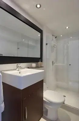 a bathroom with a sink and a toilet and a shower at Private Jacuzzi 3 Bedroom apartment in Provenza cartagena in Medellín