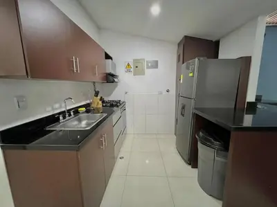 a kitchen with a sink and a refrigerator at Private Jacuzzi 3 Bedroom apartment in Provenza cartagena in Medellín